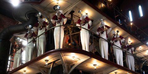 Marching Band musicians standing on a catwalk