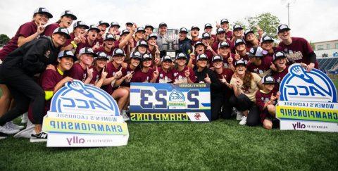 BC Women's Lax with championship banner