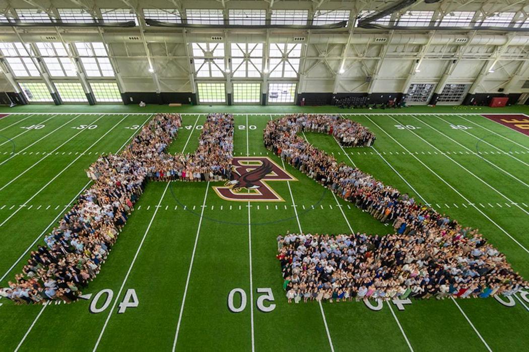 Members of the senior class pose in the shape of the number 24